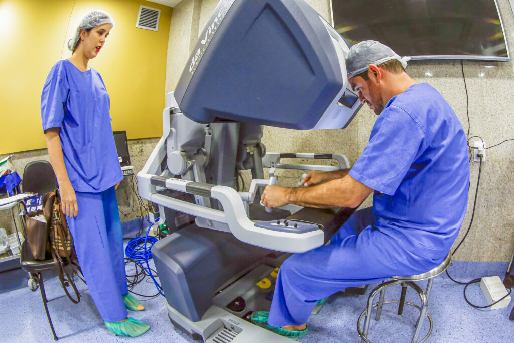 A robot-assisted operation under way, with the instrument arms over the patient