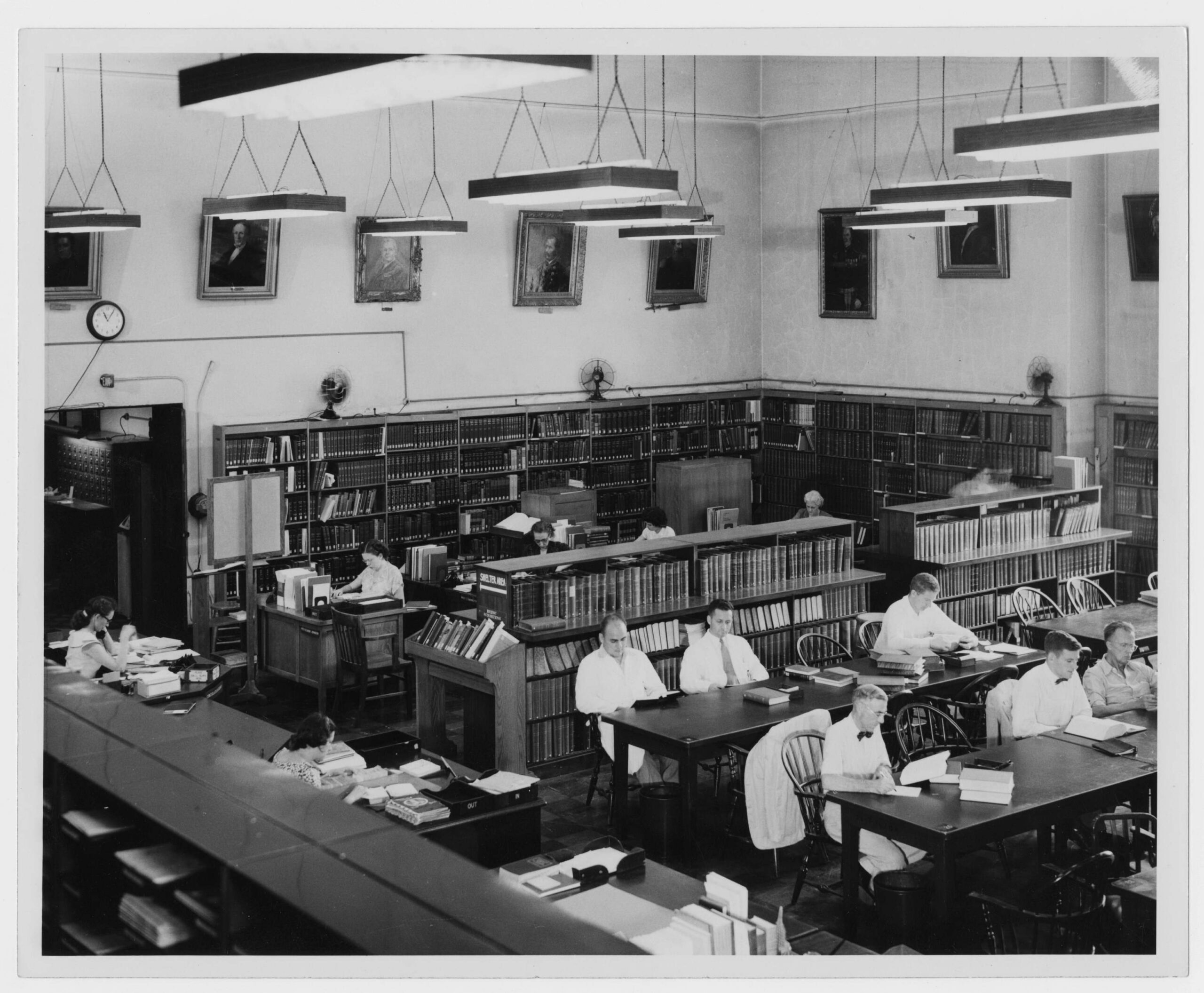 The reading room of a medical library lined with bound volumes