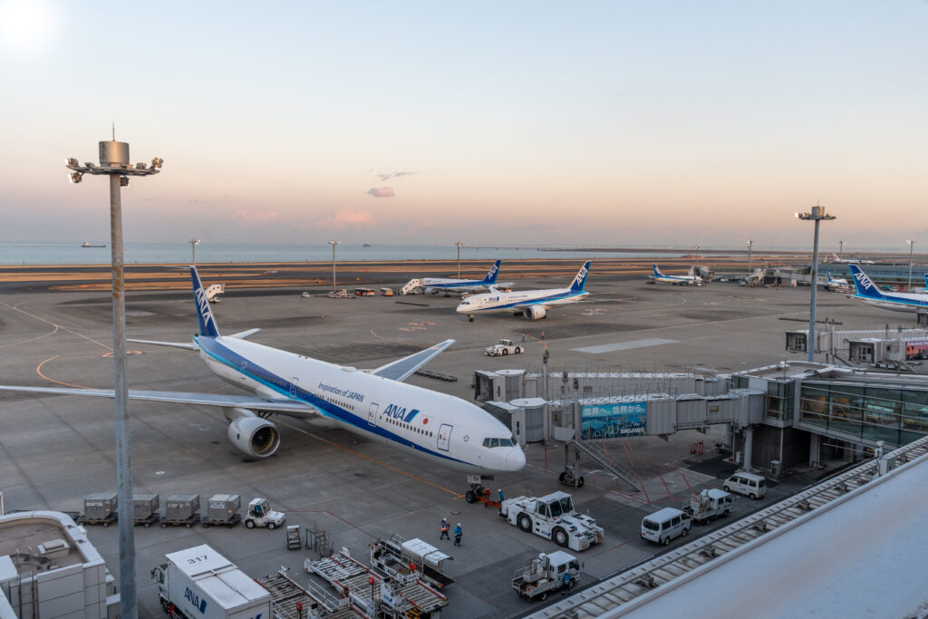 Aircraft parked on the apron at a large international airport terminal